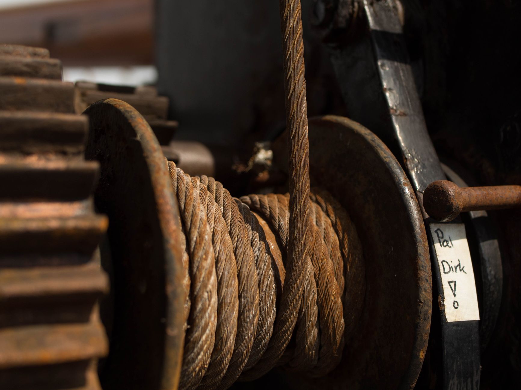 Detailed image of rusty pulleys and gears highlighting industrial strength and durability.