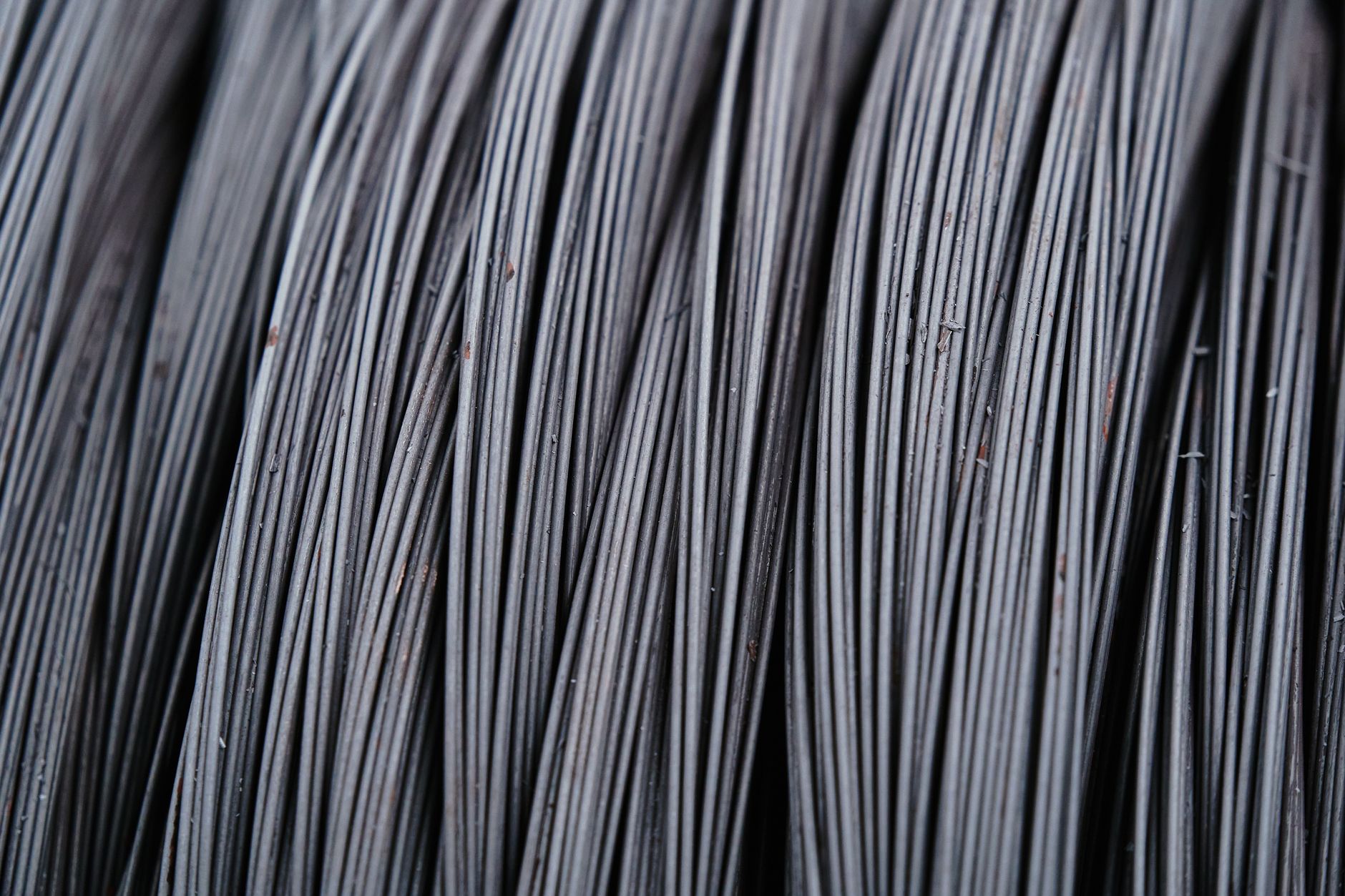 Detailed macro shot of intertwined metal wires, showcasing industrial texture.